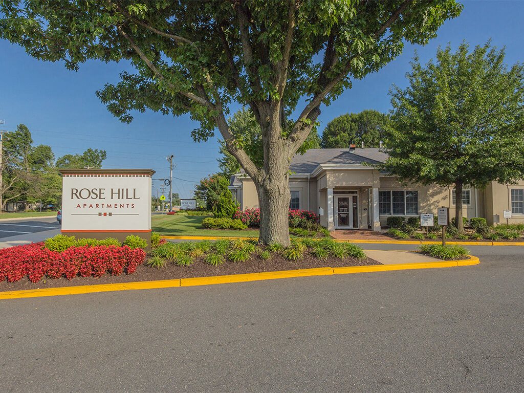 Entrance exterior and logo placard at Rose Hill Apartments in Alexandria, VA, ZIP 22310