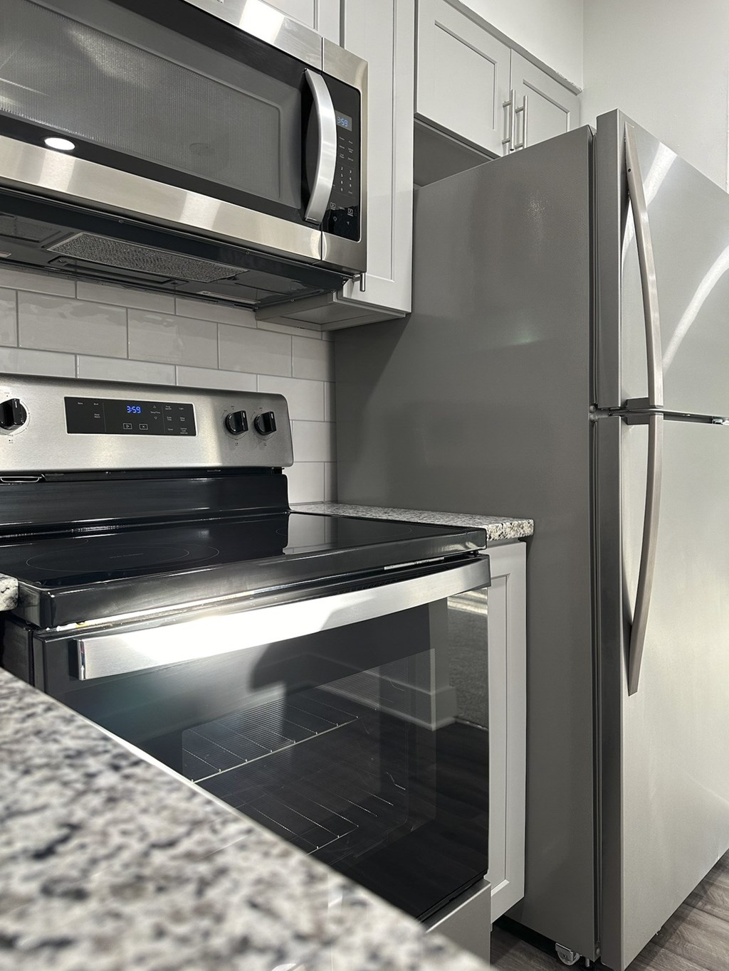 A modern kitchen with a stainless steel refrigerator and oven at Tysons Glen Apartments and Townhomes, Virginia