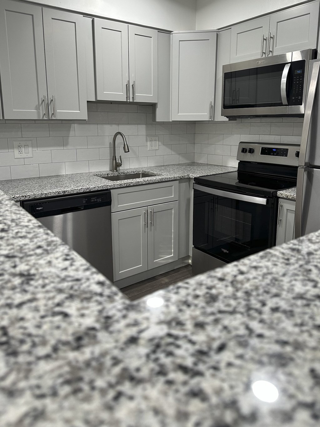 A kitchen with granite countertops and stainless steel appliances at Tysons Glen Apartments and Townhomes, Virginia