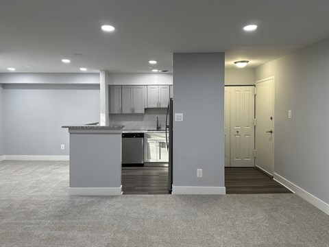 A kitchen with a white countertop and a white refrigerator is visible.