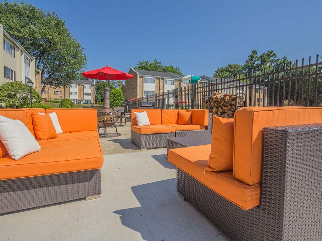 Orange outdoor couches in sunshine at Tysons Glen Apartments and Townhomes, Virginia