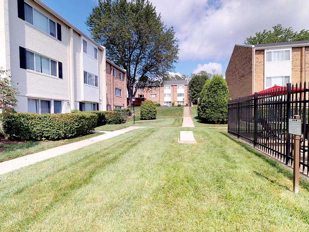 Green grass area with cornhole area at Tysons Glen Apartments and Townhomes, Falls Church, Virginia