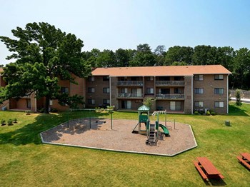 Far away view of apartment complex with playground at Gainsborough Court Apartments, Fairfax, VA - Photo Gallery 6