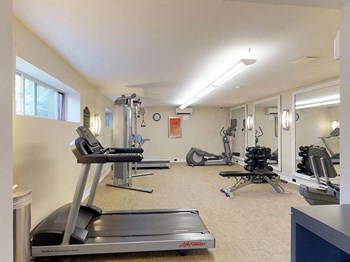 Residential gym area with treadmill and various other types of equipment at Gainsborough Court Apartments, Fairfax - Photo Gallery 12