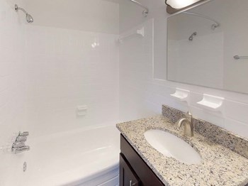 Granite counters in bathroom with sink at Gainsborough Court Apartments, Virginia - Photo Gallery 9