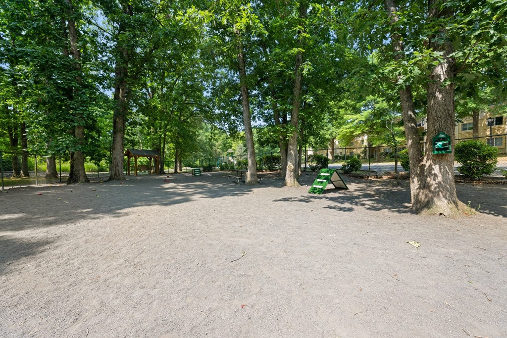 a park with trees and a green bench at Stuart Woods* Apartments, Virginia