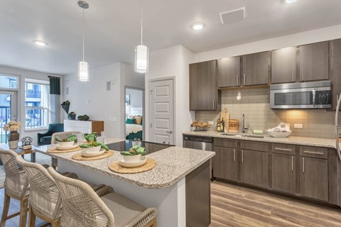an open kitchen and living room with a counter top