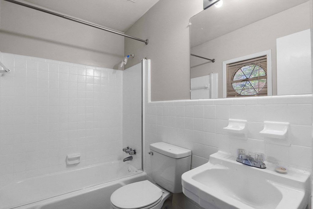 a bathroom with a sink toilet and a tub