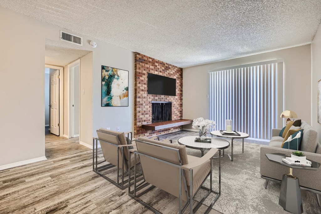A living room with a fireplace and a dining table.