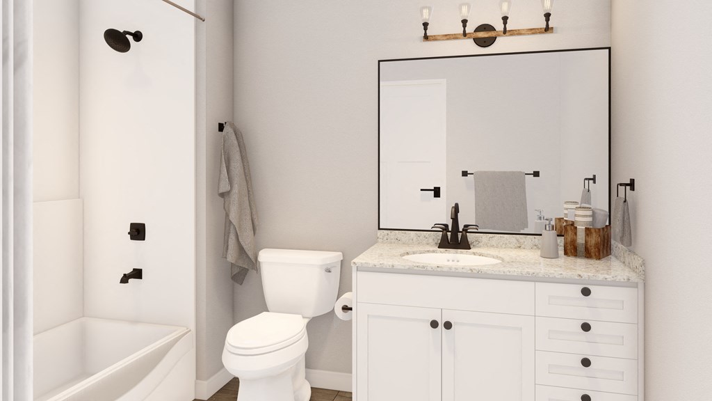 a white bathroom with a mirror and a toilet and a sink