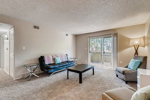 A living room with a blue couch and a coffee table.