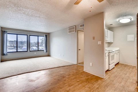 A large empty room with a washer and dryer in it.