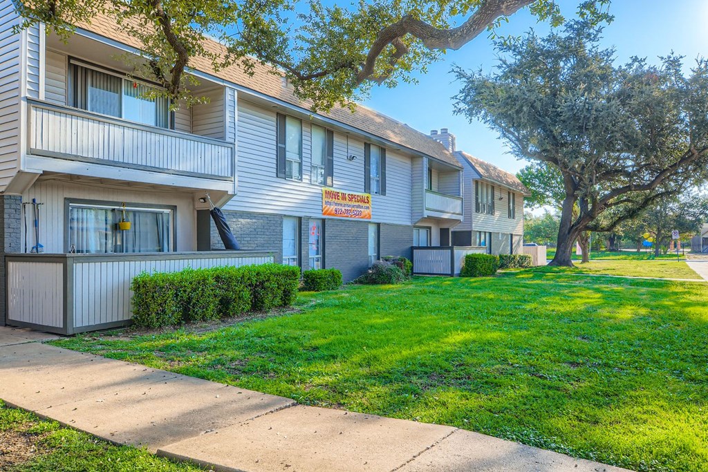 Apartment complex with a sign that says "For Rent".