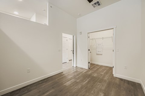 A room with a wooden floor and white walls.