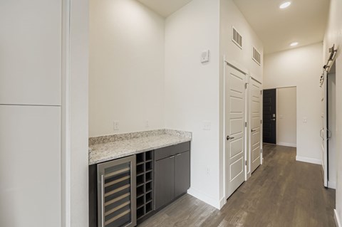 A kitchen with a granite counter top and stainless steel drawers.