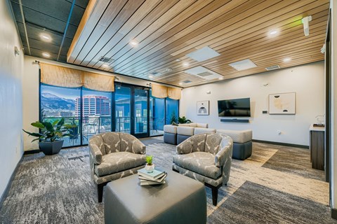 A modern living room with a large window and a flat screen TV.