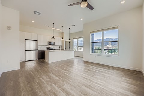 A spacious kitchen with a large island and a view of the mountains.