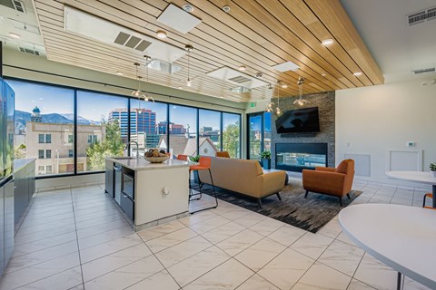 A modern living room with a kitchen island and a flat screen TV.