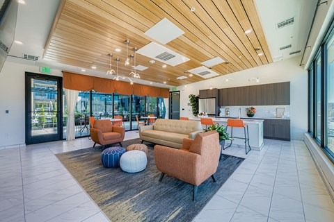 A modern living room with a wooden ceiling and a large window.