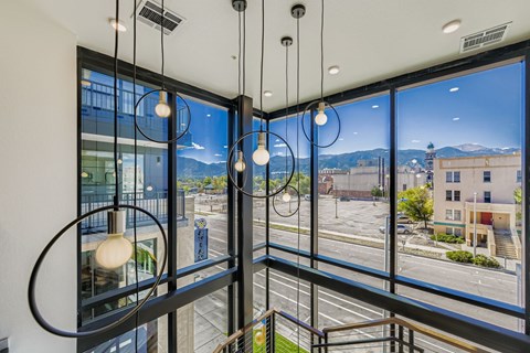 A view from a window of a parking lot and buildings outside.