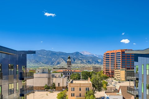 A cityscape with buildings and a church tower in the background.