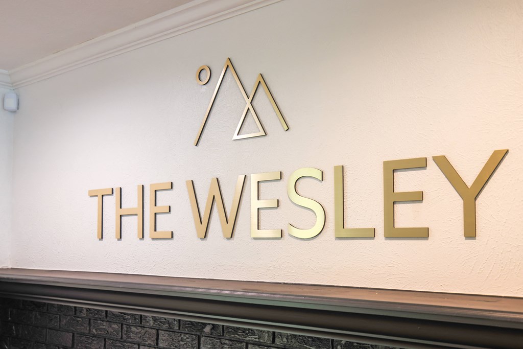 a sign for the westley on the side of a building