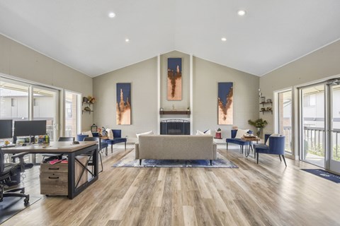 A spacious living room with a fireplace and a large painting on the wall.