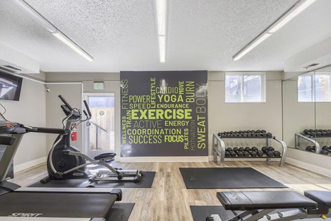 A gym with a sign that says "Power, Style, Speed, Endurance, Sweat, Energy, Focus".