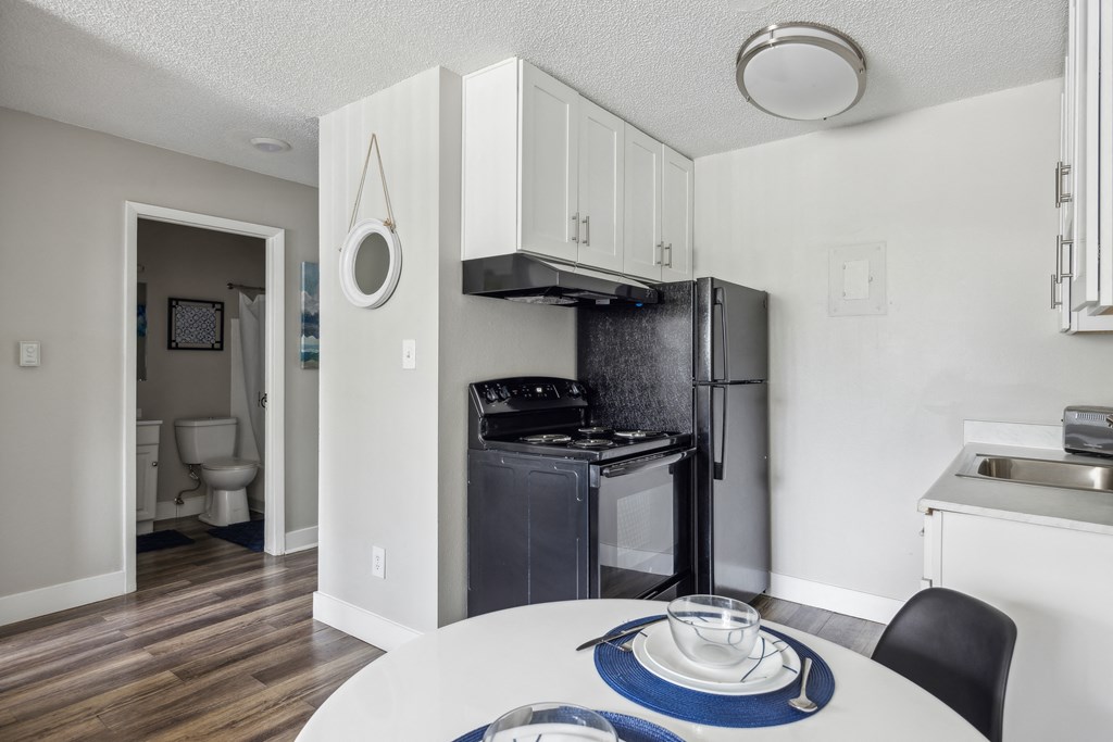 a kitchen and dining room with a table and a refrigerator