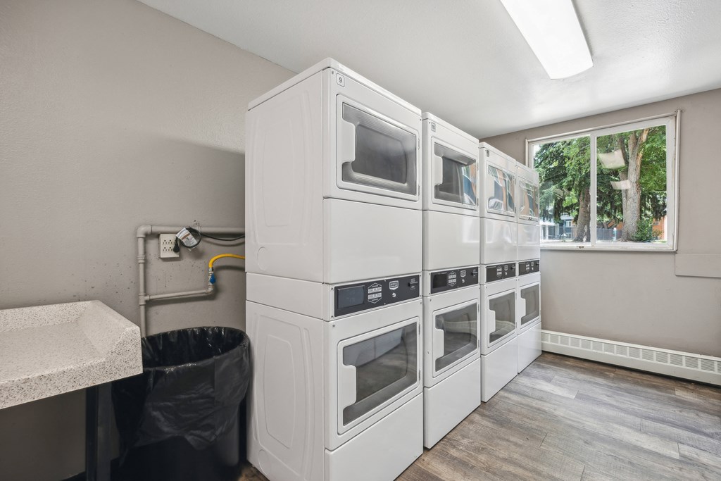 a kitchen with white appliances and a window