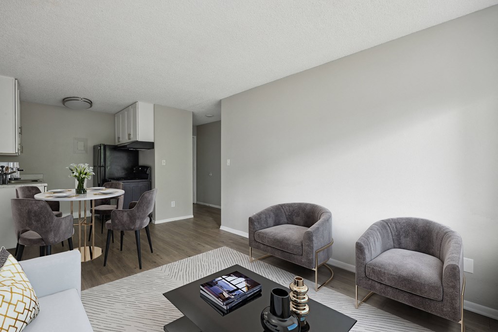 a living room and dining room with chairs and a table