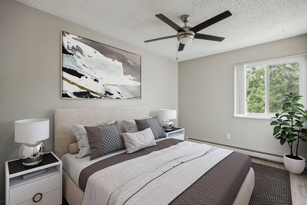 a bedroom with a large bed and a ceiling fan