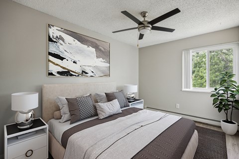 a bedroom with a large bed and a ceiling fan