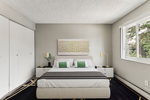 a bedroom with a bed and a large window