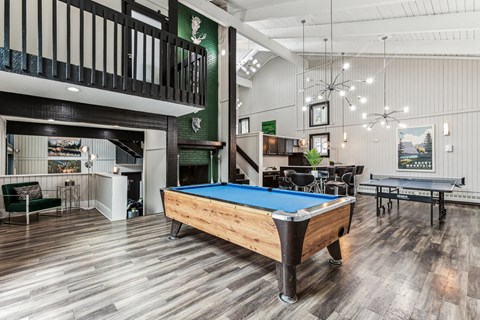 a game room with a pool table and a bar