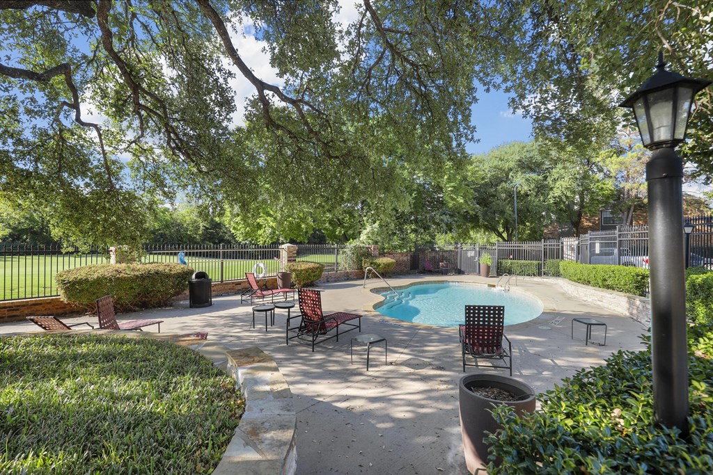 pool with three lounge chairs