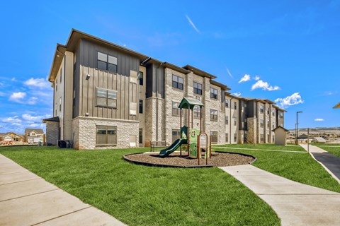 Apartment complex with a playground in the front.