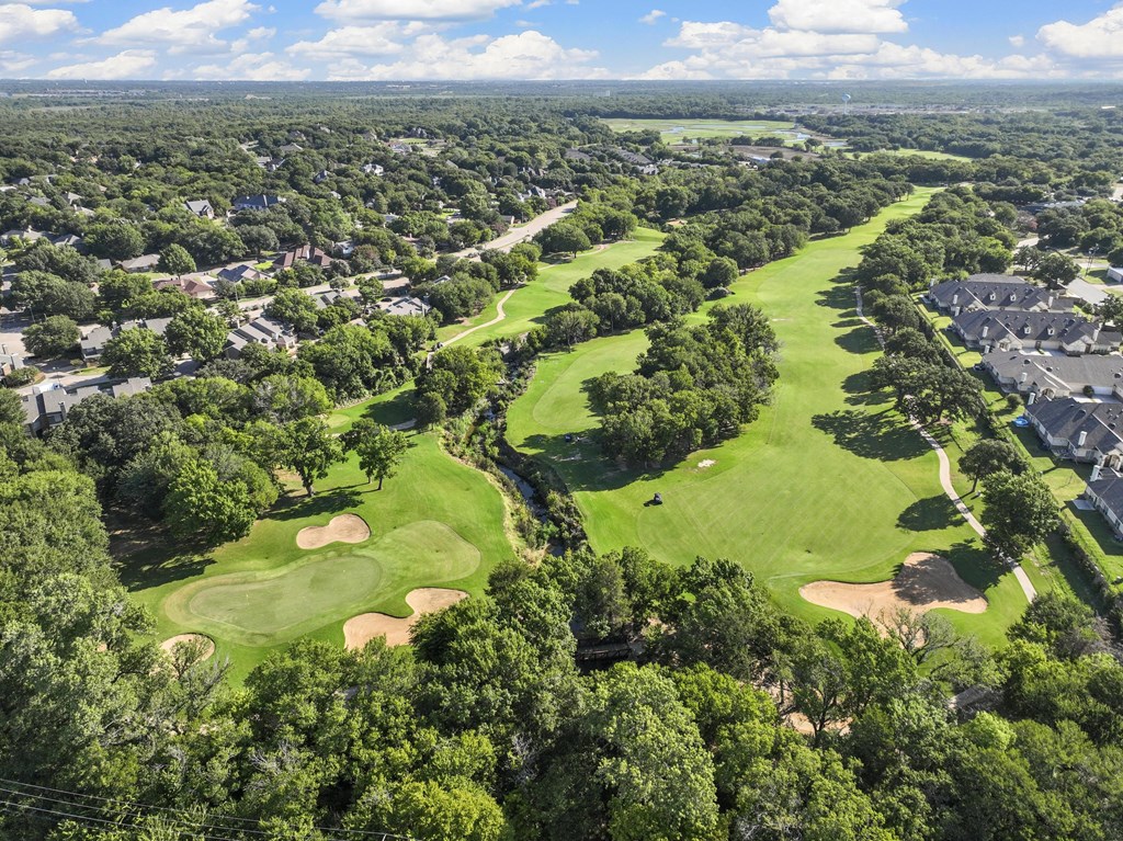 A golf course surrounded by houses.