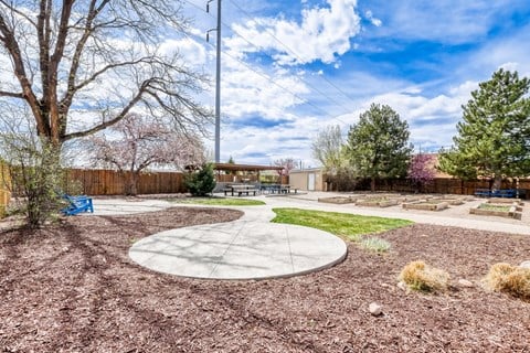A park with a playground and a bench.