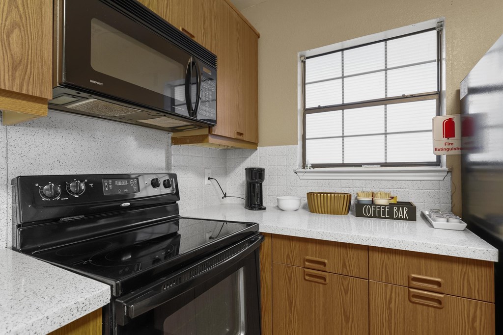 Kitchen with black stove and microwave