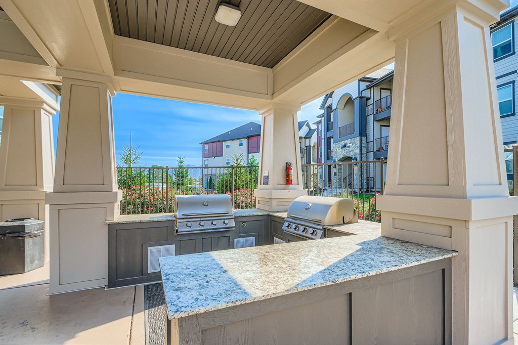 A kitchen area with a grill and a countertop.