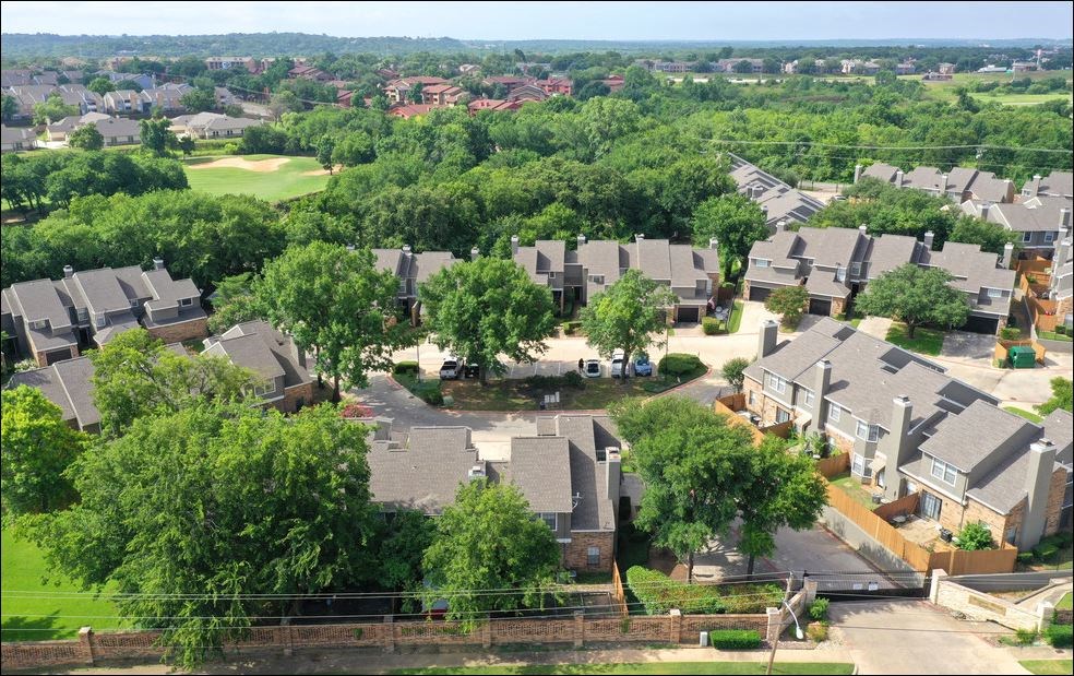 A residential area with houses and greenery.