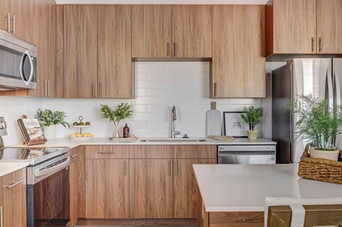 A kitchen with wooden cabinets and a white countertop.