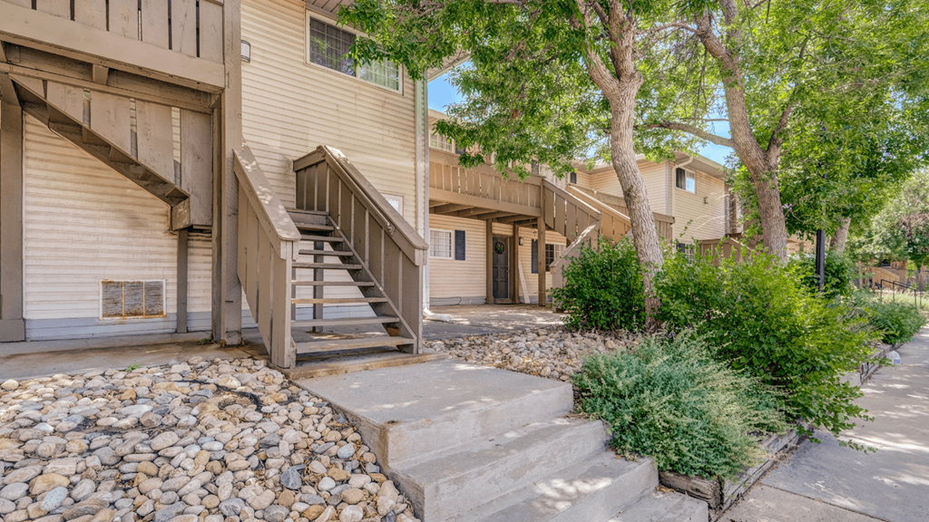 steps leading up to a house with stairs and trees