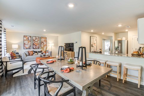 a living room and dining room with a table