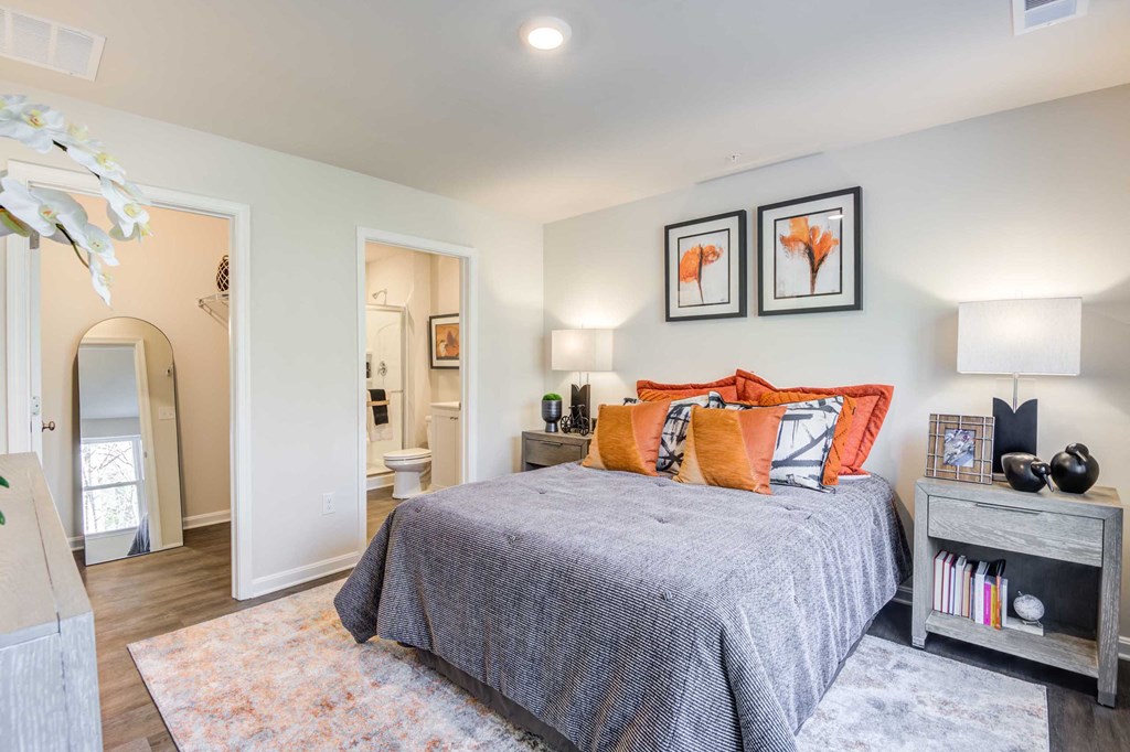 a bedroom with a bed and a door to a bathroom