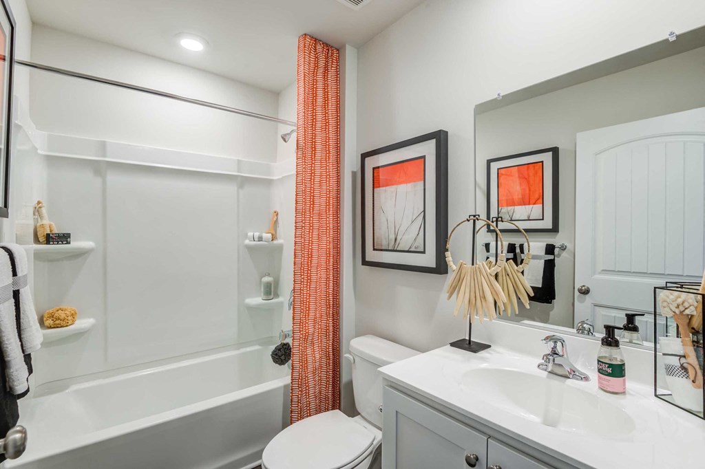 a bathroom with a shower and a sink and a toilet