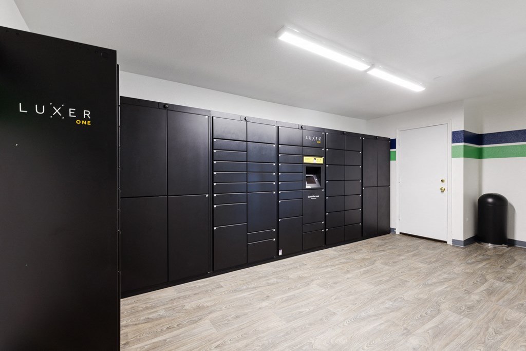 a lockers room in a building with a wood floor and lockers and a