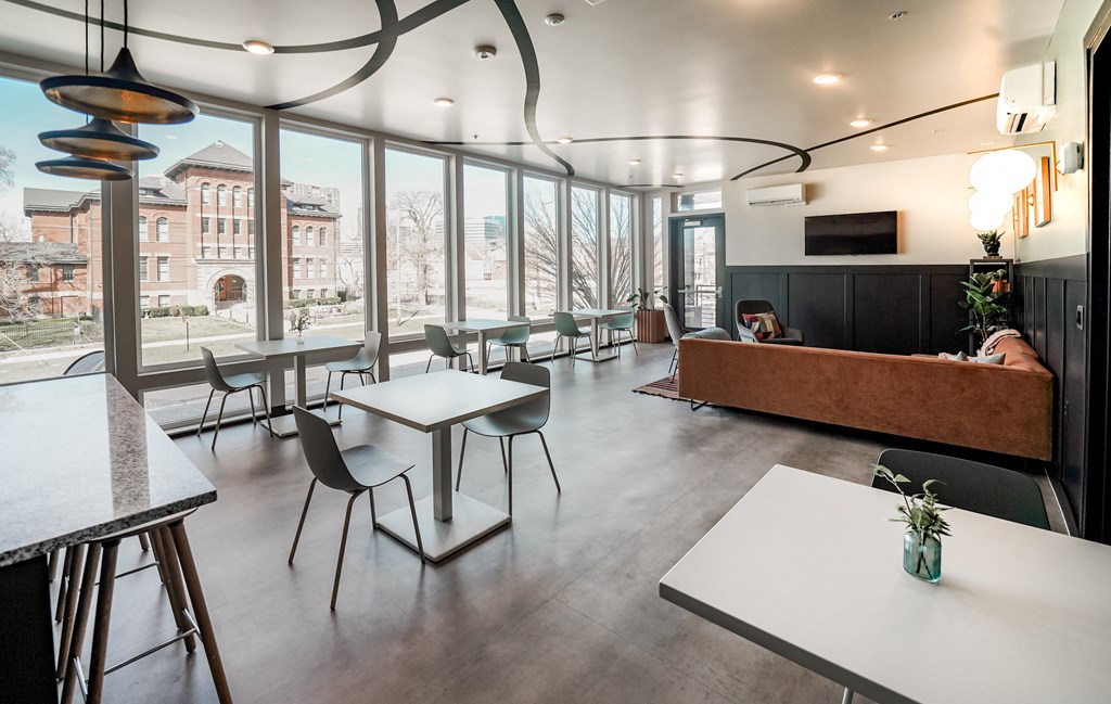 a large room with tables and chairs and a large window