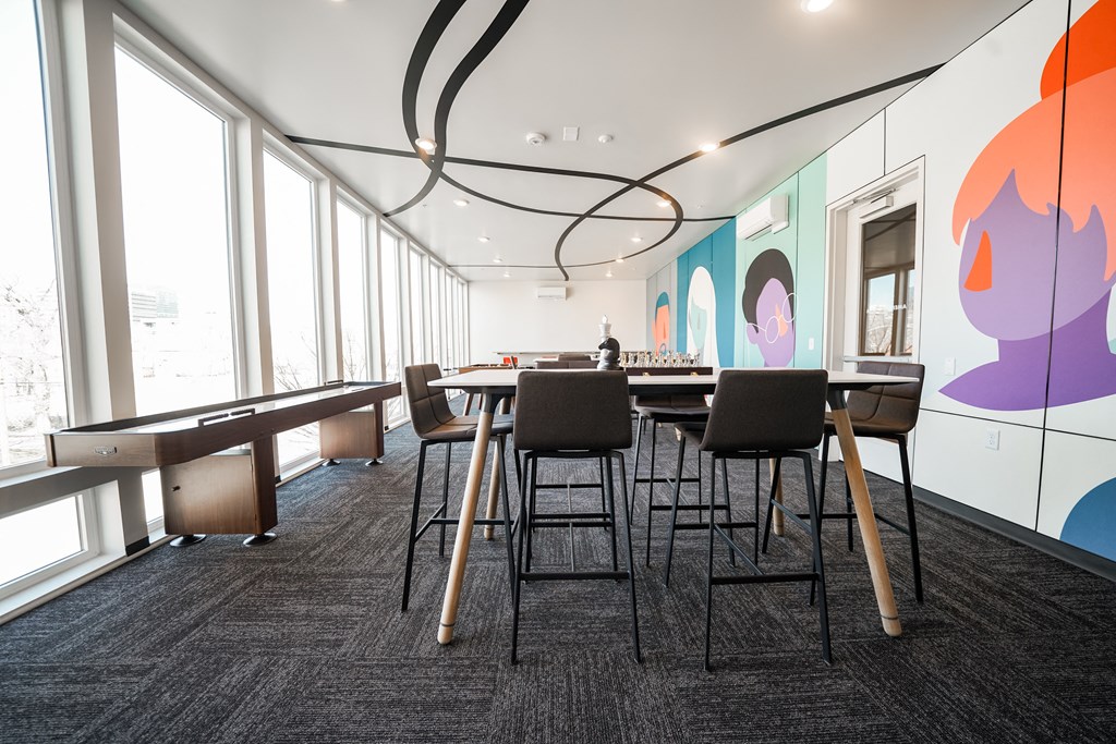 a large meeting room with tables and chairs and a large window